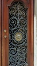 Wooden door with carved wrought iron grille, Italy, Venice Royalty Free Stock Photo