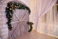 Wooden door with Christmas decorations inside of the room in studio Royalty Free Stock Photo