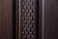 Wooden door closeup. Glossy painted wood framed panels with door windows protected by rhombus patterned metal grids