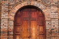 Wooden door with a cross carved in the middle at the entry of an old church in Colombia Royalty Free Stock Photo