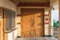 Wooden door detail with shadow of building in area of temple of Lord Shiva at Siddhesvara Dhaam in Namchi. Sikkim, India Royalty Free Stock Photo