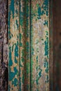 A wooden door frame with paint scratched off in a derelict old place. Blue residues of peeling. Royalty Free Stock Photo