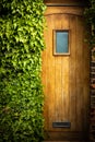 Wooden door half overgrown by ivy Royalty Free Stock Photo