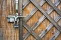 The wooden door with the hammered laths is closed on the padlock Royalty Free Stock Photo