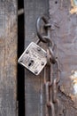 Wooden door with iron lock and chain