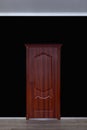 Wooden door isolated against black Royalty Free Stock Photo