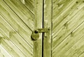 Wooden door with lock in yellow tone Royalty Free Stock Photo