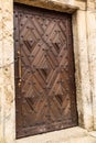 Wooden door with metal handle at the entrance to the old brick temple Royalty Free Stock Photo