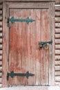 Wooden door with metal hinges.