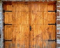 Wooden door with metal ornaments on stone wall Royalty Free Stock Photo