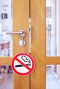 Wooden door with no smoking sign in cafe shop Royalty Free Stock Photo