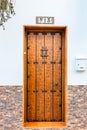 Wooden door with number thirteen on a wall Royalty Free Stock Photo