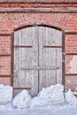 wooden door in an old brick wall. Detail of an abandoned building Royalty Free Stock Photo
