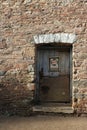 Wooden door with old `castrol` sign surrounded by nice brickwork