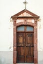 Wooden door of an old church. Vintage architecture of the rear entrance. Old church in a town Royalty Free Stock Photo