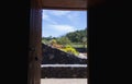 Wooden door open to reveal the view of a garden with succulent plants. Royalty Free Stock Photo