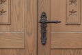 Wooden door with ornate iron handle and decorative hardware in style of baroque realism Royalty Free Stock Photo