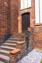Old brick wall and door. A wooden door in a red brick building. Royalty Free Stock Photo