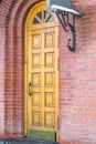 Wooden door and red brick wall closeup Royalty Free Stock Photo