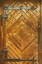 Wooden door in retro style with forged elements