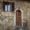 Wooden door in a small village of medieval origin. Volpaia, Tuscany, Italy Royalty Free Stock Photo