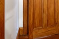 A wooden door stands slightly ajar