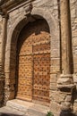 Wooden door and stone arch in ancient ChÃÂ¢teaudouble church. Royalty Free Stock Photo