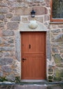 Wooden door with stone scallop shell, symbol of Camino de Santiago. Galicia, Spain. Royalty Free Stock Photo