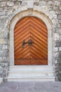 Wooden door in stone wall Royalty Free Stock Photo