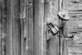 Wooden door surface with handle, old padlock, old metal and wooden latches. Wooden background and space for text. Royalty Free Stock Photo