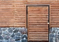 Wooden door to the utility room of a house standing on a stone foundation Royalty Free Stock Photo