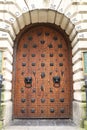 Wooden door with vintage Lion Face Shaped knocker and wrought iron details Royalty Free Stock Photo