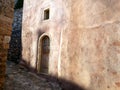 Wooden door and wall of an old house with interesting texture and colours, Monemvasia, Greece