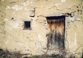 Wooden door and window on old abandoned house of clay in abandoned Serbian village Royalty Free Stock Photo