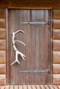 Wooden doors antler Royalty Free Stock Photo