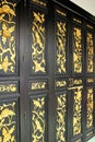 Wooden doors are painted golden patterns on the door. Royalty Free Stock Photo