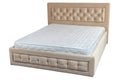 Wooden double bed with cream faux leather, and orthopedic mattresses. Royalty Free Stock Photo