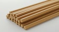 Wooden dowels arranged in a neat stack on a light surface. Each dowel is cylindrical, Royalty Free Stock Photo