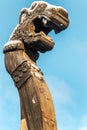 Wooden dragon head on Drakkar on blue sky background
