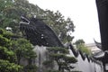 Wooden Dragon sculpture on the top of the wall in the famous Yu Garden on downtown of Shanghai