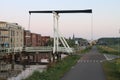 Wooden drawbridge called Witte Brug during sunrise in the town of Nieuwerkerk aan den IJssel over the ring canal of the Zuidplaspo