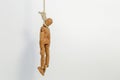 A wooden drawing mannequin hanging from a rope I