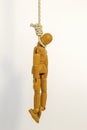 A wooden drawing mannequin hanging from a rope III Royalty Free Stock Photo