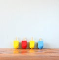 Wooden dreidels for hanukkah (spinning top) over wooden background Royalty Free Stock Photo