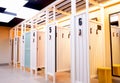 Wooden dressing booths for trying on clothes from the store. Clean, bright, comfortable and empty fitting rooms.