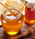 Wooden dripper in glass can full of honey. Royalty Free Stock Photo