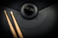 Wooden Drumsticks on a Black Cymbal of an Electronic Drum Kit