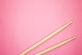 Wooden drumsticks on pink back