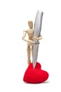 wooden dummies with a knife stabbing into a red heart, isolated Royalty Free Stock Photo