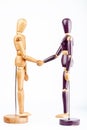 Wooden dummies shaking hands